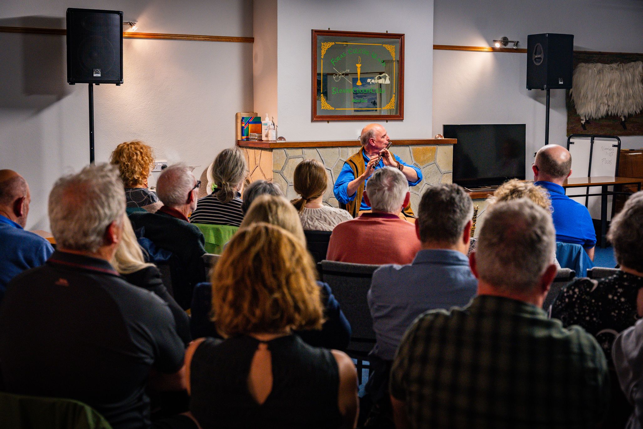 Gary Hastings playing on the flute in front of a crowd
